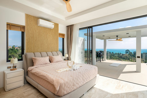 Elegant master bedroom with king bed, sea view, and direct terrace access — wake up to paradise at Villa Gala.
