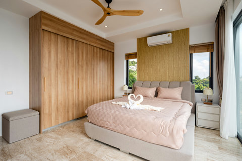 Elegant bedroom with warm lighting and ocean views at Villa Gala, Chaweng Noi
