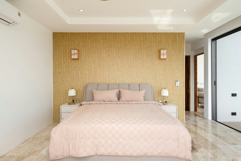 Warm tones and natural textures make the master suite at Villa Gala a serene escape for restful nights in Koh Samui.