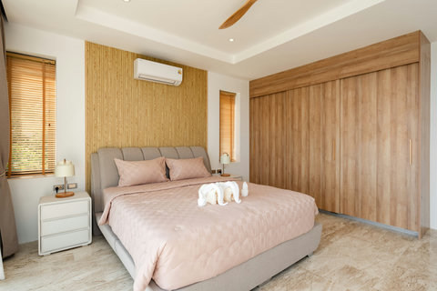 Guest suite with lounge area and soft tones at Villa Gala, luxury Koh Samui rental