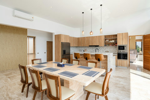 Indoor dining area with pendant lights and ocean view at Villa Gala, Chaweng Noi