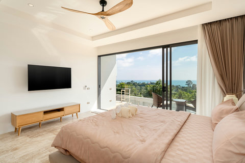 Bright guest bedroom with private balcony, smart TV, and panoramic sea view — unwind in style at Villa Gala.