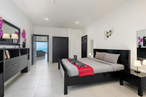 Comfortable bedroom with colorful accents and natural light at Villa SKY, Nathon Koh Samui