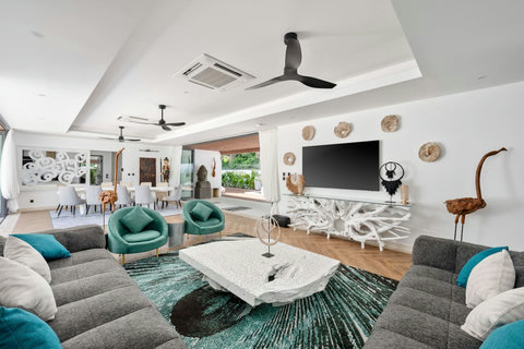 Spacious open-plan living room with stylish furnishings and entertainment area