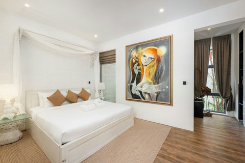 Bright and airy bedroom with comfortable beds, hardwood floors, and modern styling