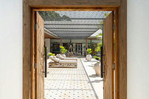 Grand entrance framing a captivating view through to the villa's ornate courtyard