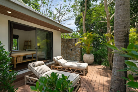 Relaxing outdoor daybed lounge overlooking the pool and tropical garden