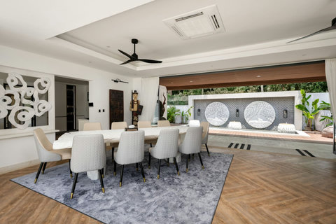 Grand open-air dining area with seating for large groups overlooking the terrace
