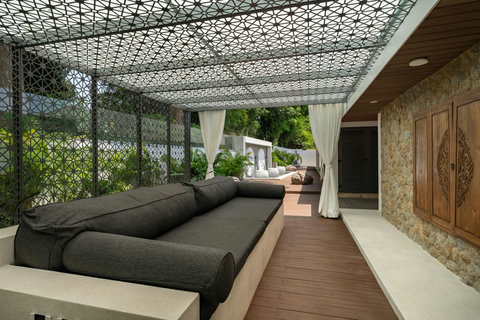 Artistic geometric canopy shading a relaxing outdoor seating area with mountain views