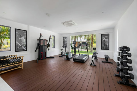 Fully equipped private gym with fitness equipment and wine storage