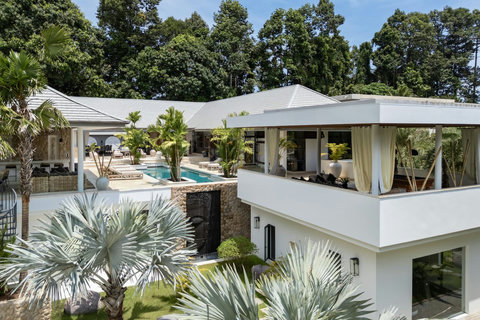 Aerial view of the villa estate showcasing the pool, multiple pavilions, and tropical setting