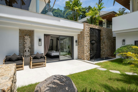 Modern villa frontage with water feature and beautifully landscaped tropical gardens