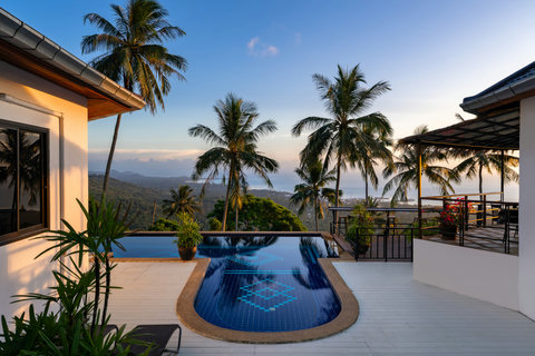 Relax by the redience shared pool with ocean-facing terrace and tropical palms