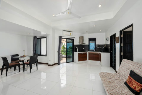 Stylish hallway with natural stone accent wall and modern design at Moonview Paradise Village Koh Samui