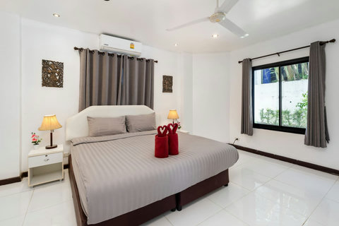 Comfortable bedroom with colorful tropical accents at Moonview Paradise Village Koh Samui