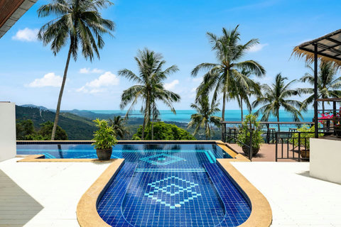 Covered terrace with swaying palms and panoramic seaview at Moonview Paradise Village Koh Samui
