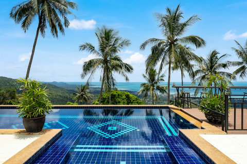 Stunning infinity pool at twilight with Gulf of Thailand ocean views at Moonview Paradise Village Koh Samui