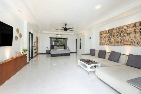 Spacious modern living room with elegant white furnishings at Moonview Paradise Village Koh Samui