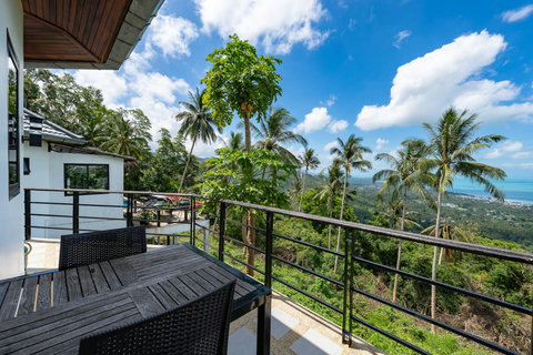 Private balcony with tropical garden and ocean view from Koh Samui seaview bungalow