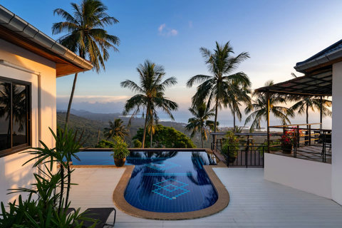 Twilight view of Koh Samui vacation bungalows with palm trees and tropical evening ambiance