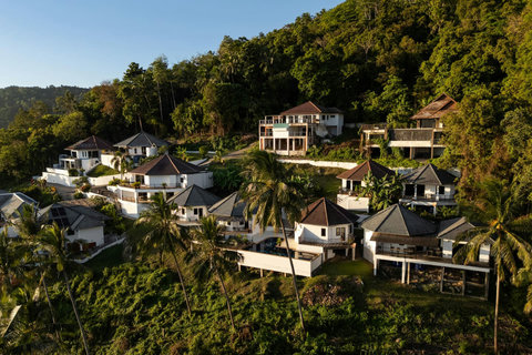 Hillside Koh Samui vacation bungalows surrounded by lush tropical gardens and palm trees