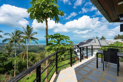 Bright open-plan interior with terrace access and panoramic sea views in Koh Samui vacation bungalow