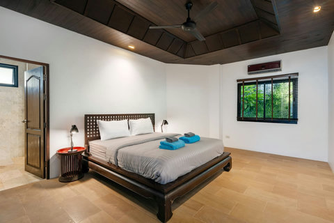 Bright bedroom with modern canopy bed and tropical décor at Sunhouse - Koh Samui villa Paradise Village