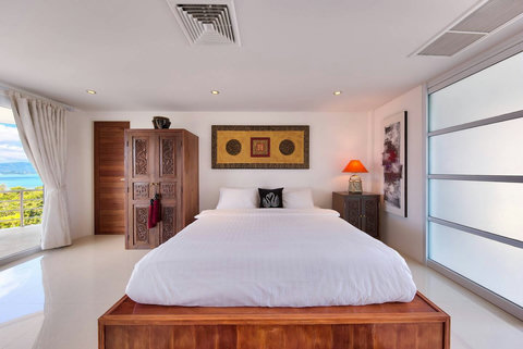 Elegant bedroom with wooden headboard and warm lighting