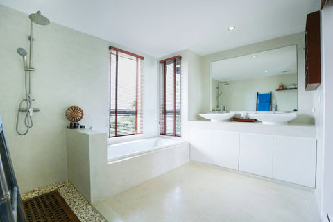 Clean modern bathroom with white tile vanity and natural light