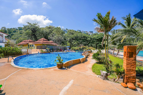 Villa exterior with traditional architecture and palm trees