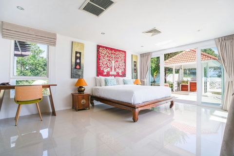 Traditional Thai-style bedroom with twin beds and wooden furnishings