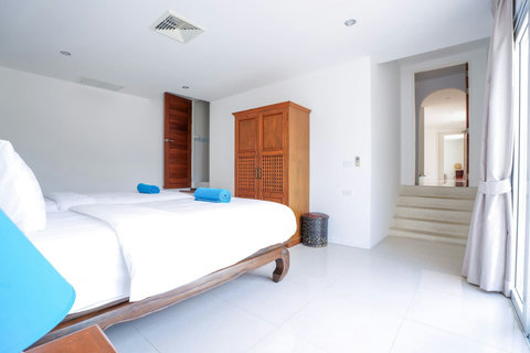 Comfortable bedroom with fresh white linens and blue accents