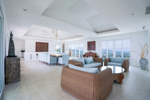 Spacious covered terrace with comfortable seating and panoramic sea views