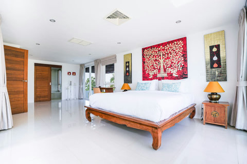 Spacious bedroom with twin queen beds and colorful accent pillows