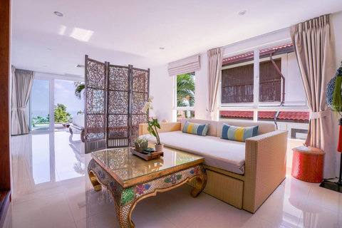 Bright sitting area with rattan furniture and colorful tropical cushions