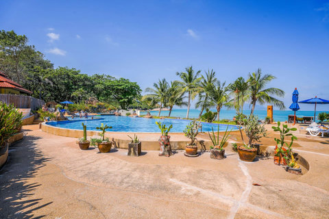 Resort grounds with pool and lush tropical gardens