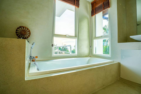 Modern bathroom with luxurious soaking tub and glass shower partition