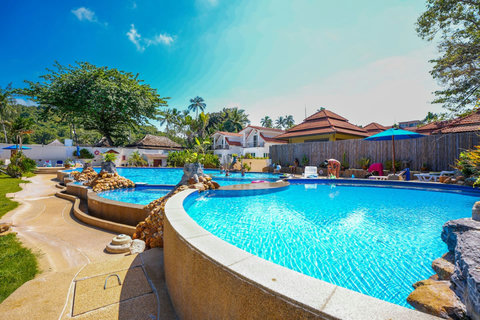Resort swimming pool with tropical surroundings