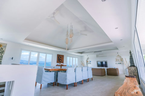 Elegant white dining area with wooden table and matching chairs