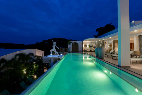 Illuminated private pool at night with ambient lighting at C Villa, a premium Koh Samui vacation rental