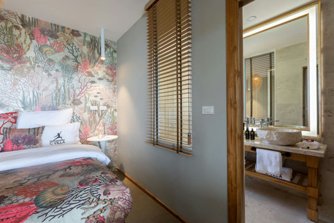 Luxurious bathroom with freestanding bathtub and natural stone finishes at C Villa, Koh Samui Thailand