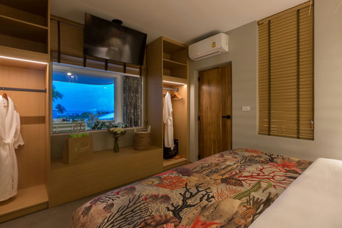 Entertainment-ready bedroom with large screen and stylish decor at C Villa, Koh Samui private retreat