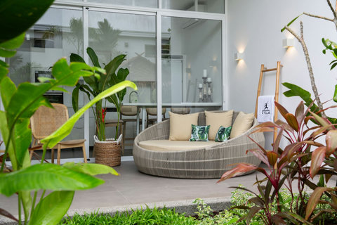 Tranquil outdoor nook with rattan daybed and tropical plants at C Villa, Koh Samui holiday rental