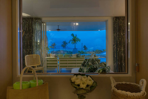 Breathtaking evening view from the terrace with illuminated pool and palm trees at C Villa, Koh Samui