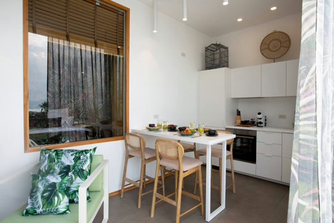Indoor dining room with designer pendant lighting and tropical accents at C Villa, Koh Samui villa