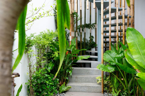 Enchanting garden entrance with stone pathway and tropical landscaping at C Villa, Koh Samui Thailand