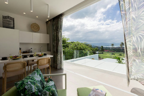 Indoor-outdoor living space with mountain views and ceiling fan at C Villa, Koh Samui vacation home