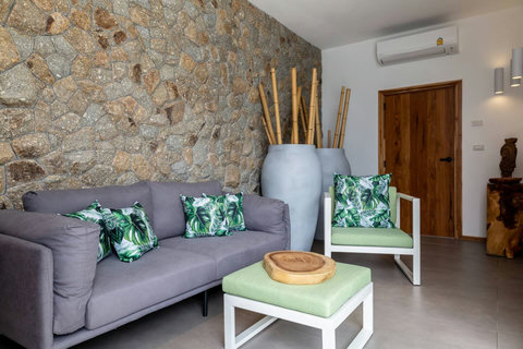 Comfortable TV lounge with tropical cushions and modern furnishings at C Villa, Koh Samui Thailand