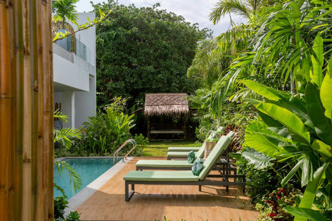 Tropical garden pool area with palm trees and lush greenery at C Villa, 6-bedroom Koh Samui rental