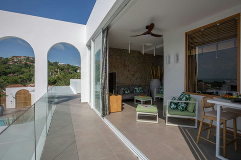 Breezy covered balcony with hilltop sea views and comfortable seating at C Villa, Koh Samui rental